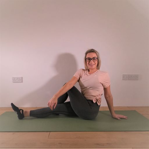 Pilates instructor demonstrating pilates stretch