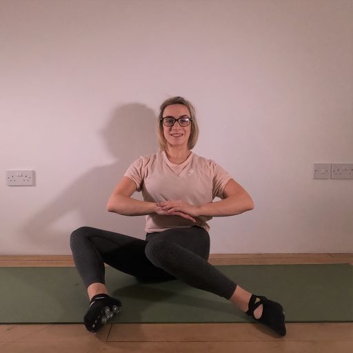 Pilates instructor demonstrating pilates exercise